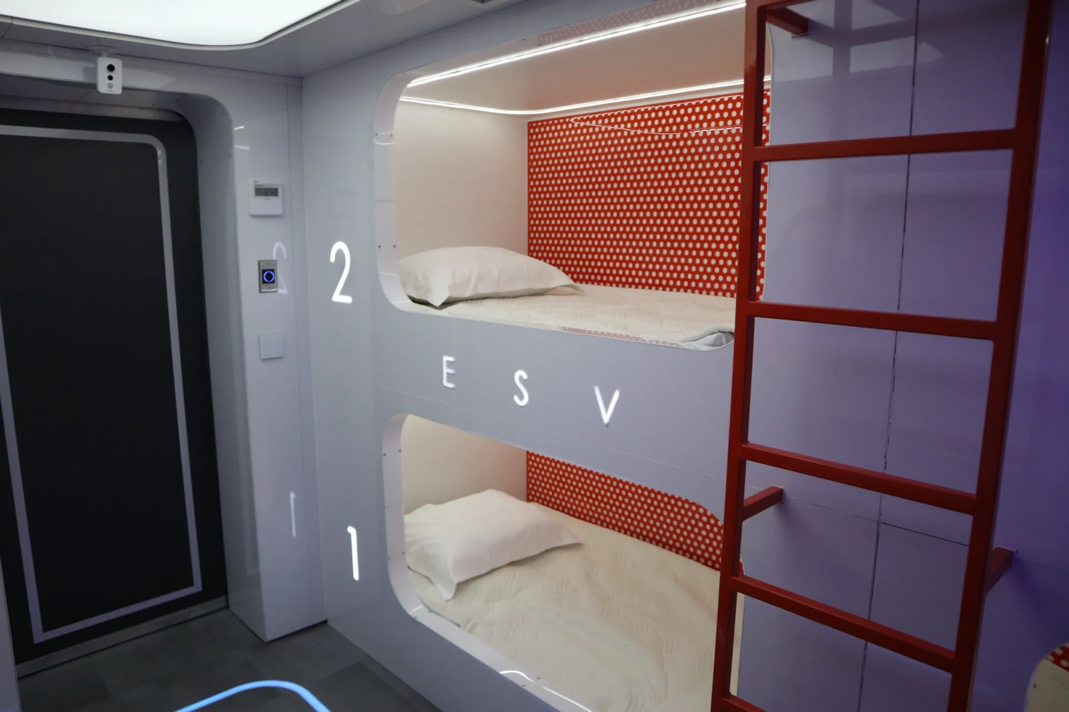 Numbered bunk beds in the living module of the SPACE NOMAD (photo credit: QazMonitor)